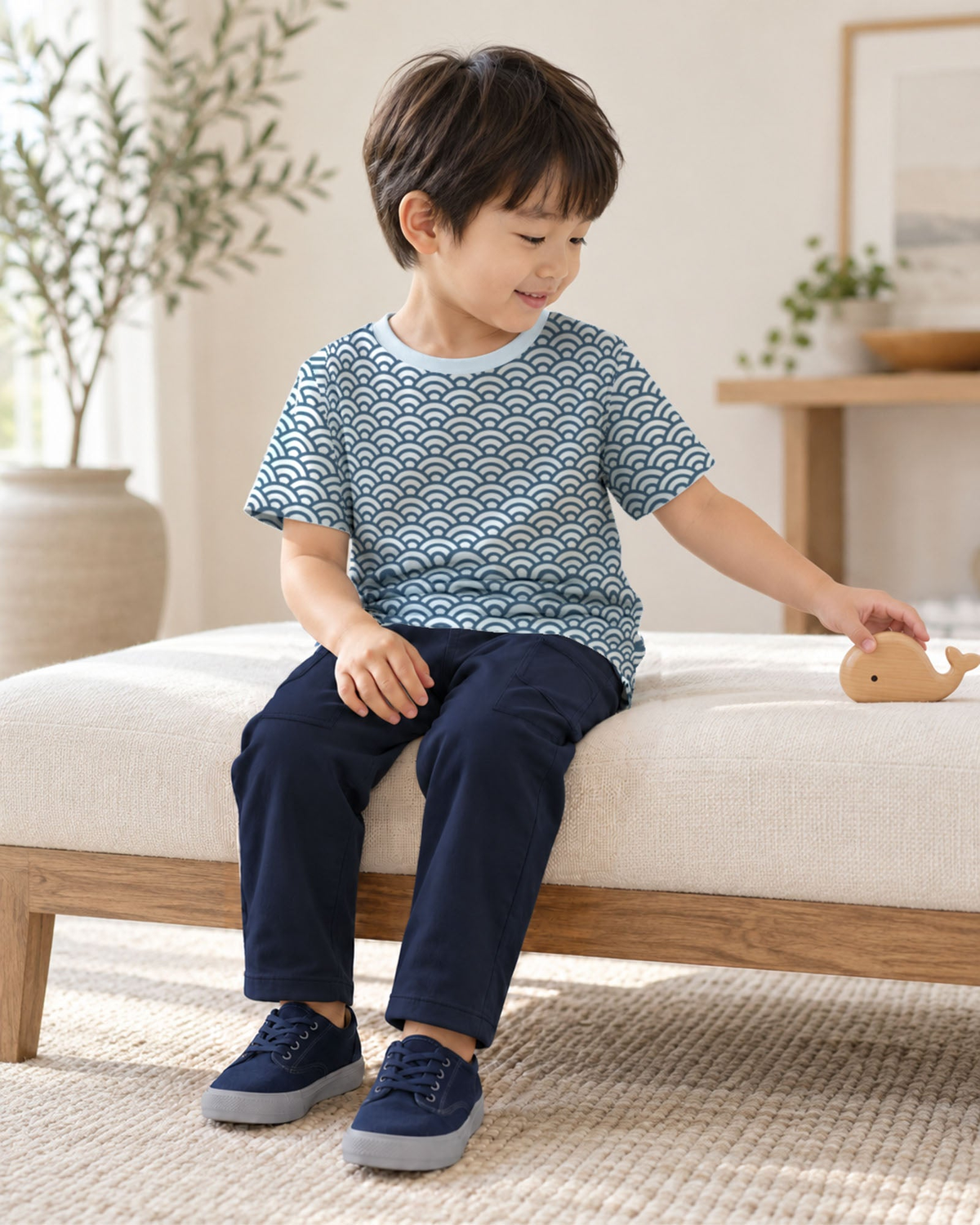 Fresh Air Wavesの波柄半袖クルーネックTシャツを着て、ベンチに座り木の積み木で遊ぶモデル